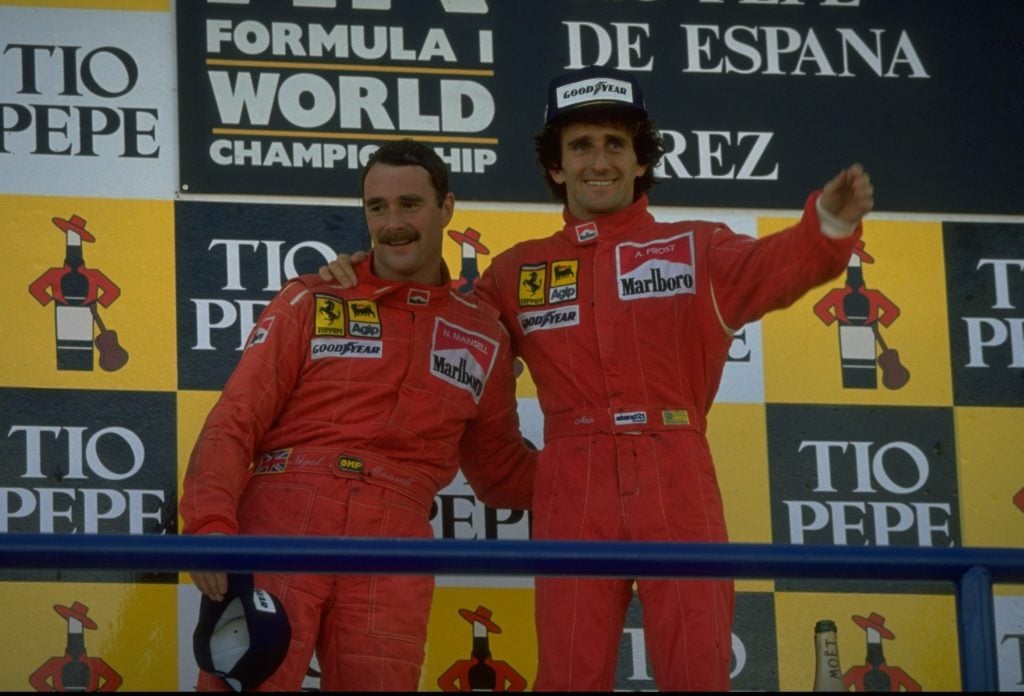 Scuderia Ferrari drivers Nigel Mansell (left) of Great Britain and Alain Prost (right) of France stand on the winners'' podium after the Spanish Gr...